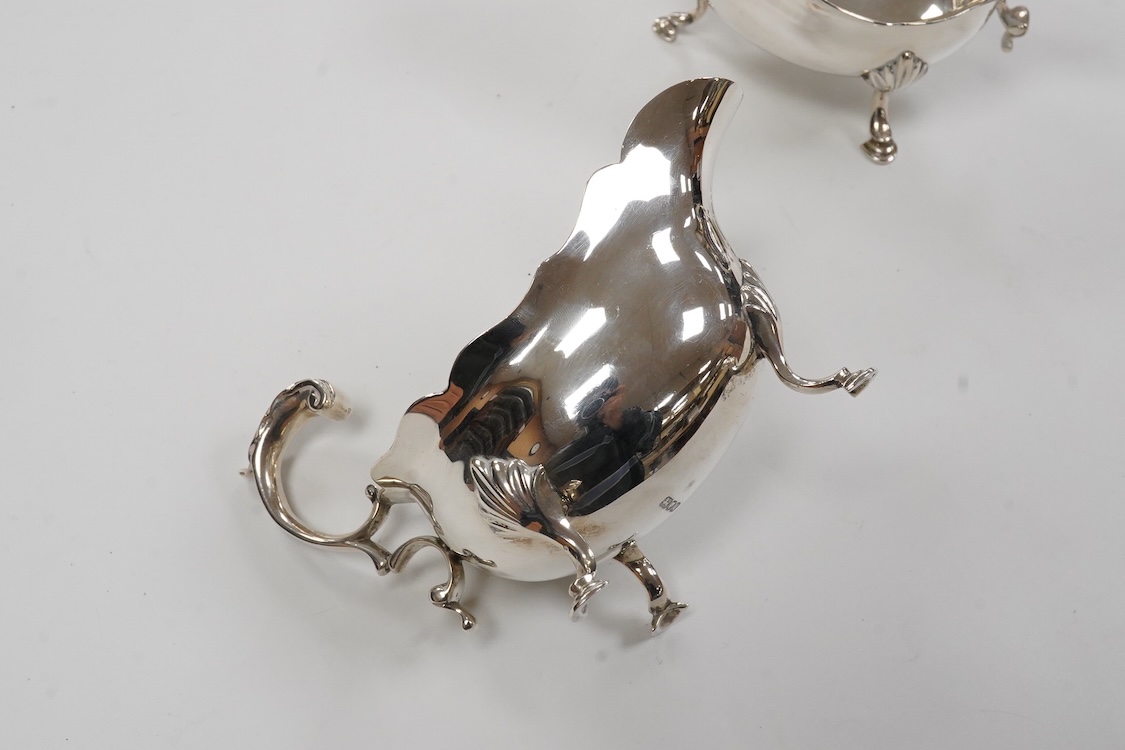 A pair of George VI silver sauce boats, with flying scroll handles, by C.J. Vander Ltd, London, 1948, length 14.3cm, 11oz.